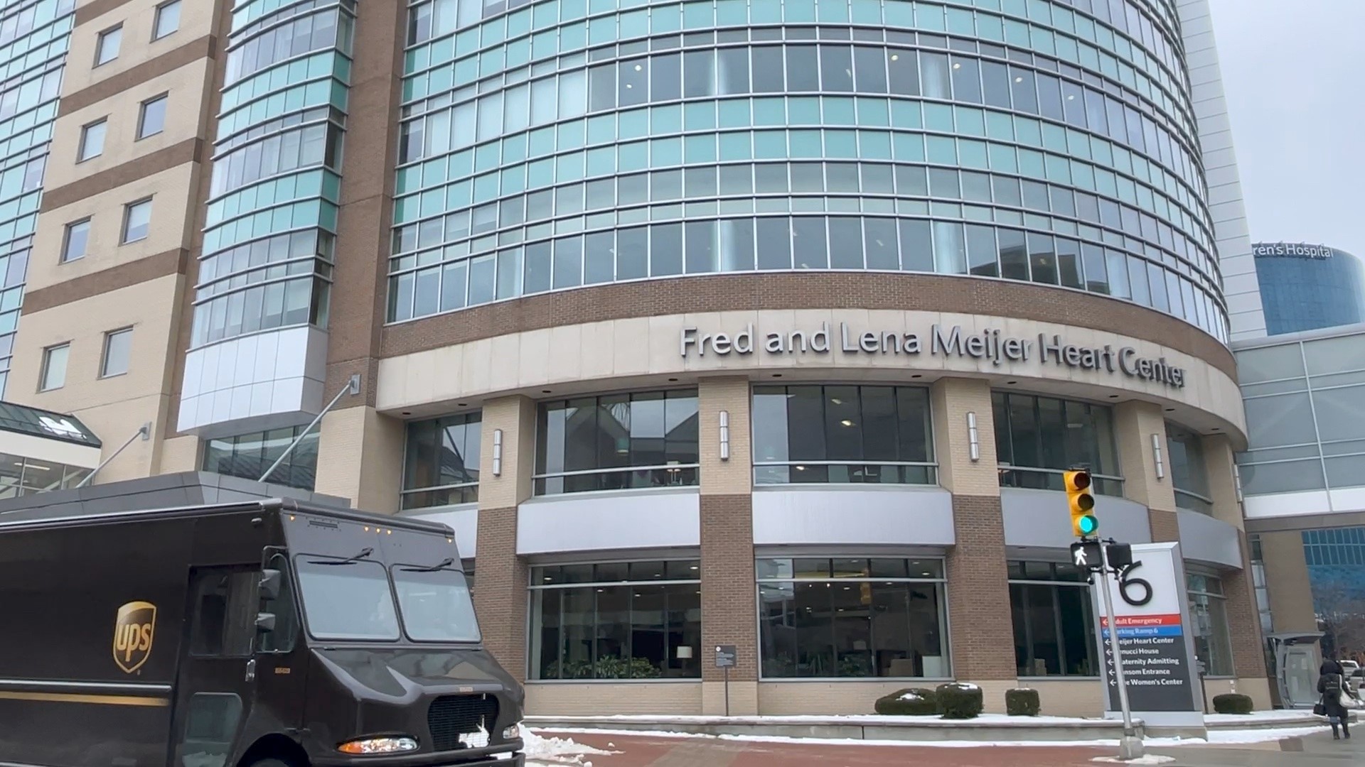 UPS truck at intersection in front of building with sign that says Fed and Lena Meijer Heart Center
