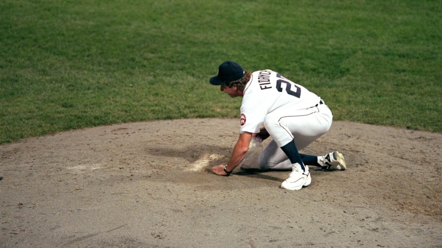 The always eclectic Mark Fidrych gathers some dirt from the pitcher’s mound following Detroit’s final game at Tiger Stadium on Sept. 27, 1999. (Ezra Smith/Getty Images)