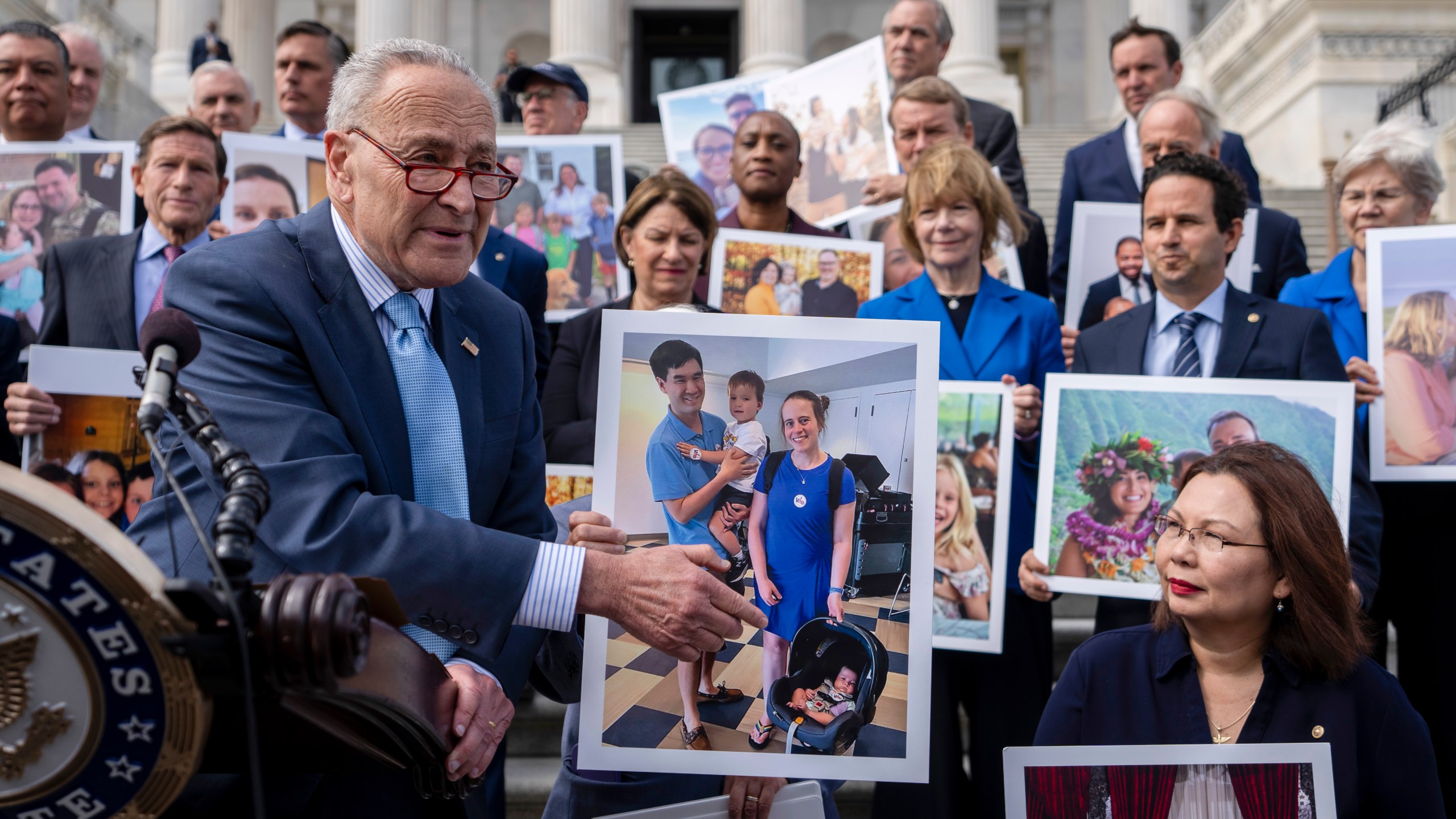 Senate Majority Leader Chuck Schumer, D-NY, left, accompanied by Sen. Tammy Duckworth, D-Ill., right, speaks about the need to protect rights to in vitro fertilization (IVF), on the Senate steps at the Capitol in Washington, Tuesday, Sept. 17, 2024. (AP Photo/Ben Curtis)