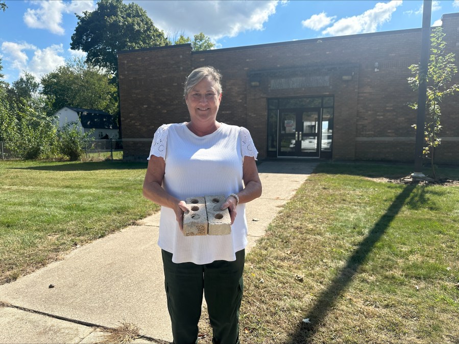 Diane Wolf holding bricks from Moline Elementary School. (Sept. 25, 2024)