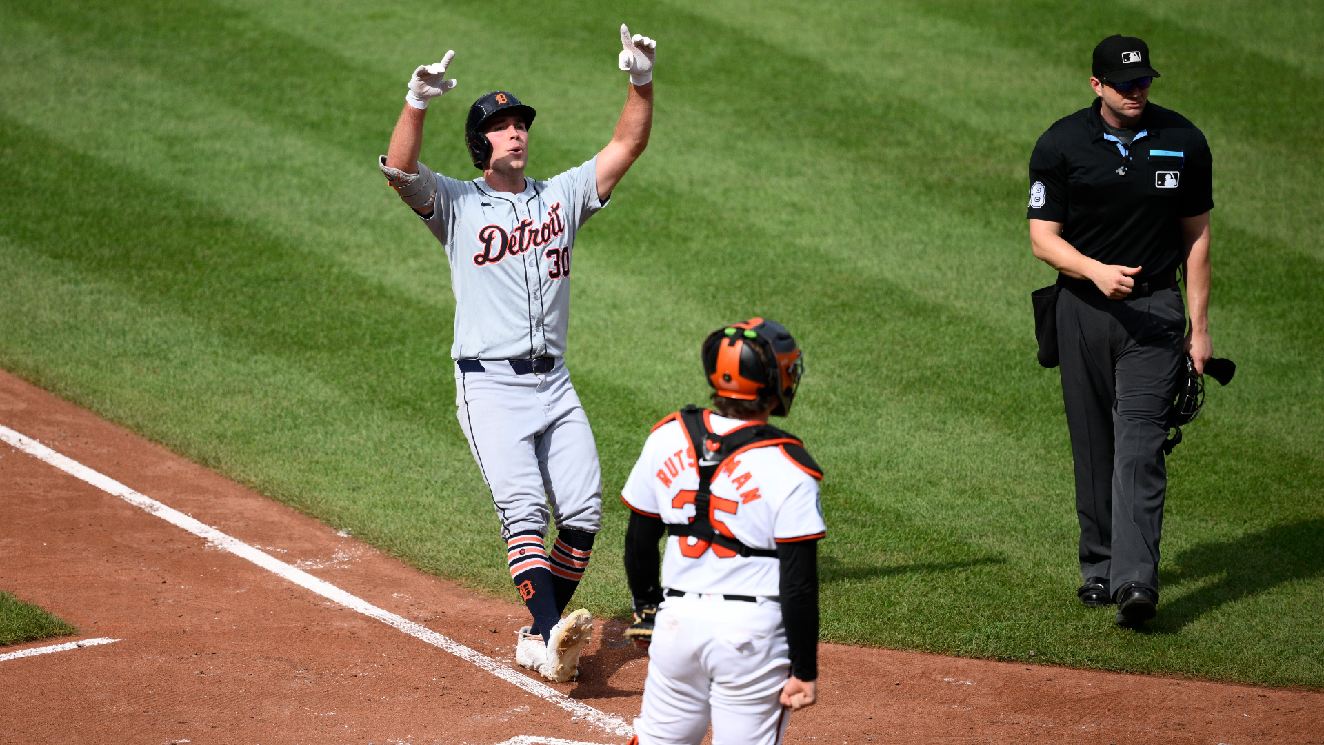 Detroit Tigers' Kerry Carpenter, left, celebrates after his home run in front of Baltimore Orioles catcher Adley Rutschman (35) during the sixth inning of a baseball game, Sunday, Sept. 22, 2024, in Baltimore. (AP Photo/Nick Wass)
