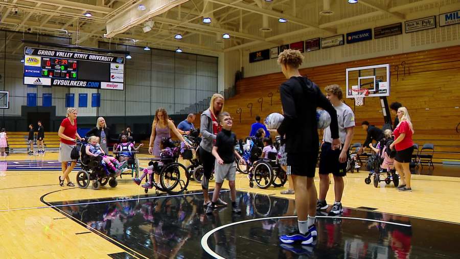 Grand Valley State University basketball players work with people with disabilities through the Beautiful Lives Project's Court of Dreams event on Sept. 18, 2024.