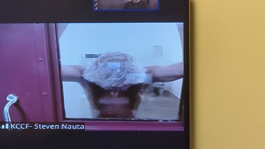 Steven Nauta takes his shirt off as he appears in court via video for arraignment on Sept. 30, 2024.