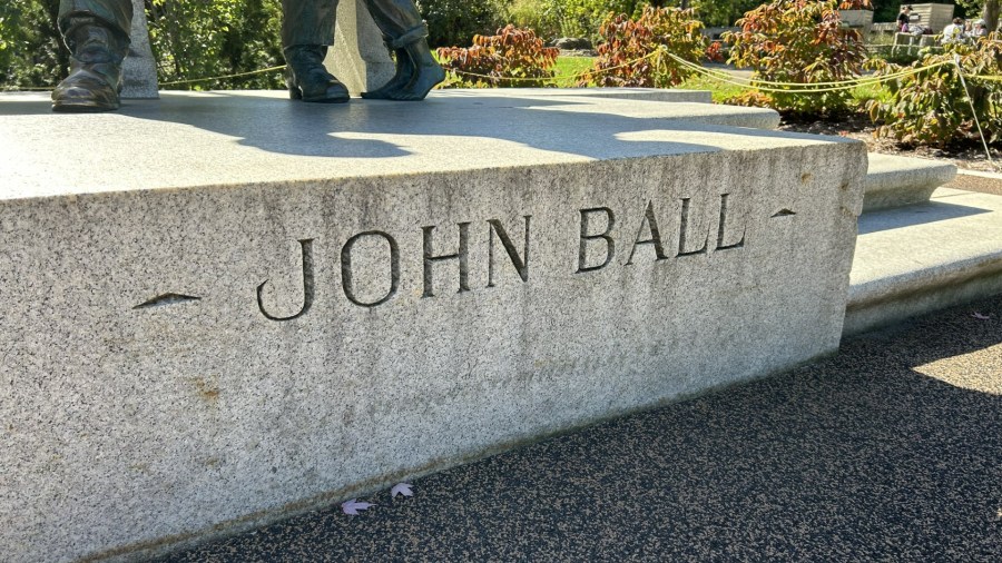 A large slab of white granite serves as the base for Pompeo Coppini’s 1925 sculpture of John Ball. (Matt Jaworowski/WOOD TV8)