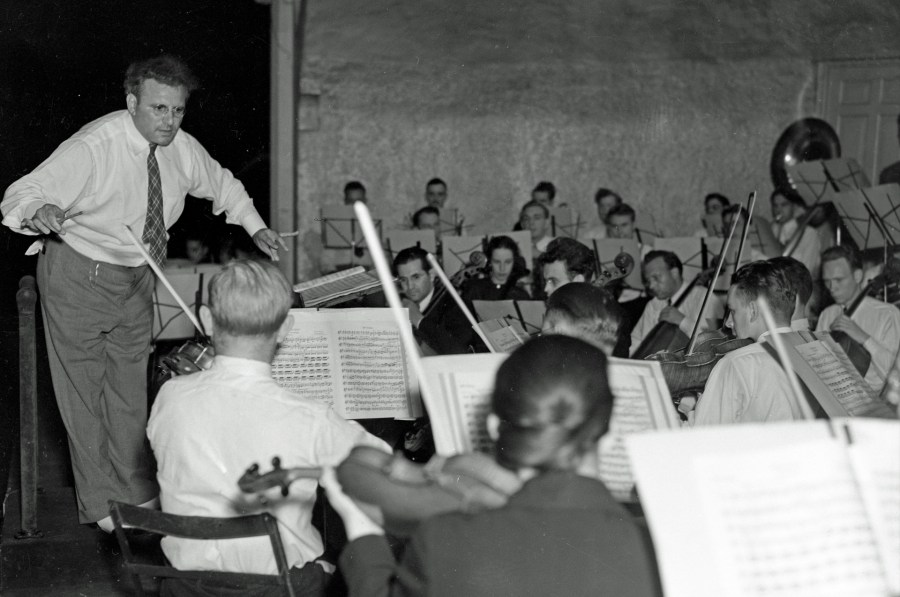 A 1937 photo of a conductor and his orchestra performing at the band shell at John Ball Park. (Courtesy Grand Rapids Public Library)