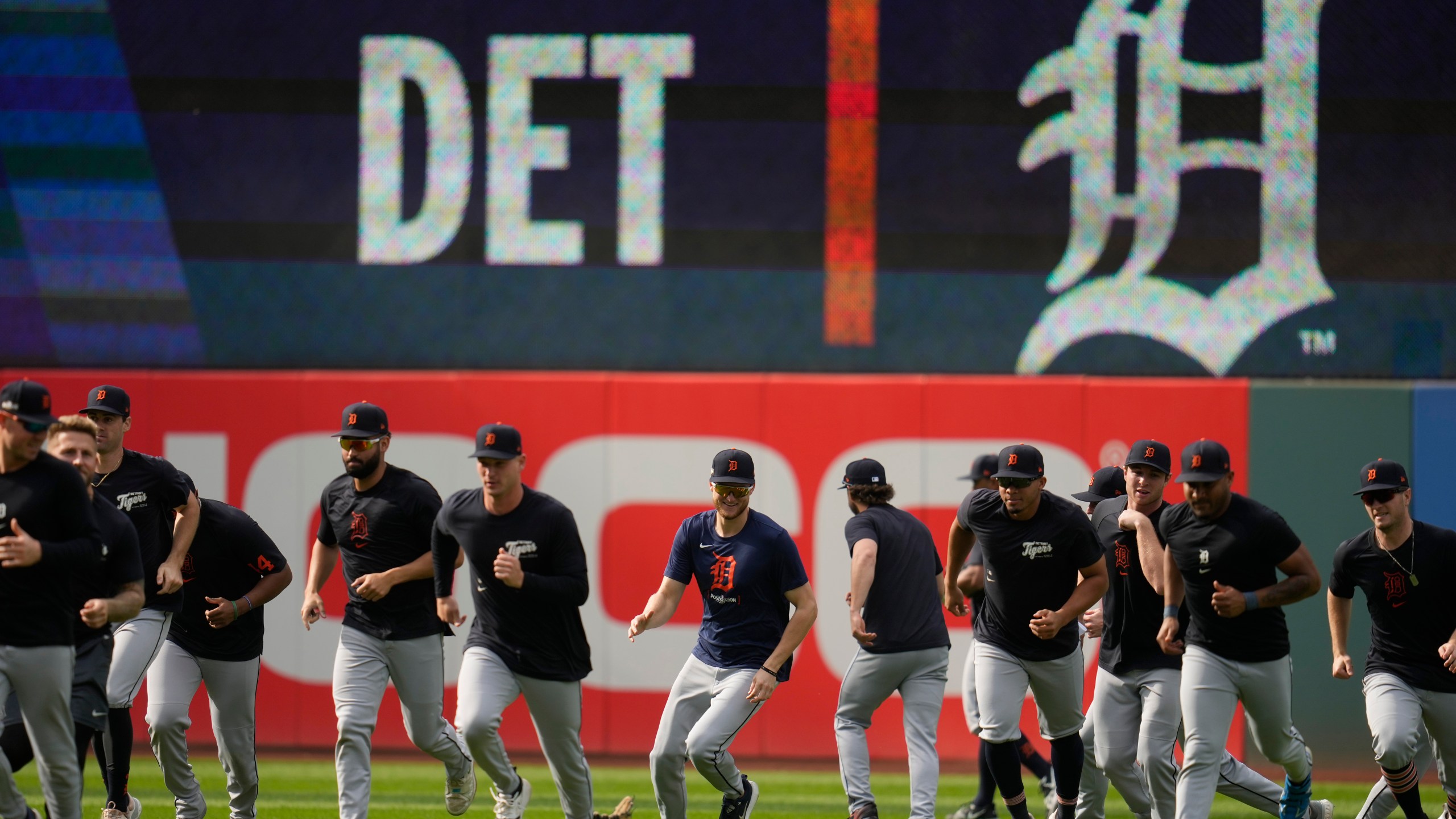 The Detroit Tigers run in from the outfield during a baseball workout in Cleveland, Friday, Oct. 4, 2024, in preparation for the American League Division Series against the Cleveland Guardians. (AP Photo/Sue Ogrocki)