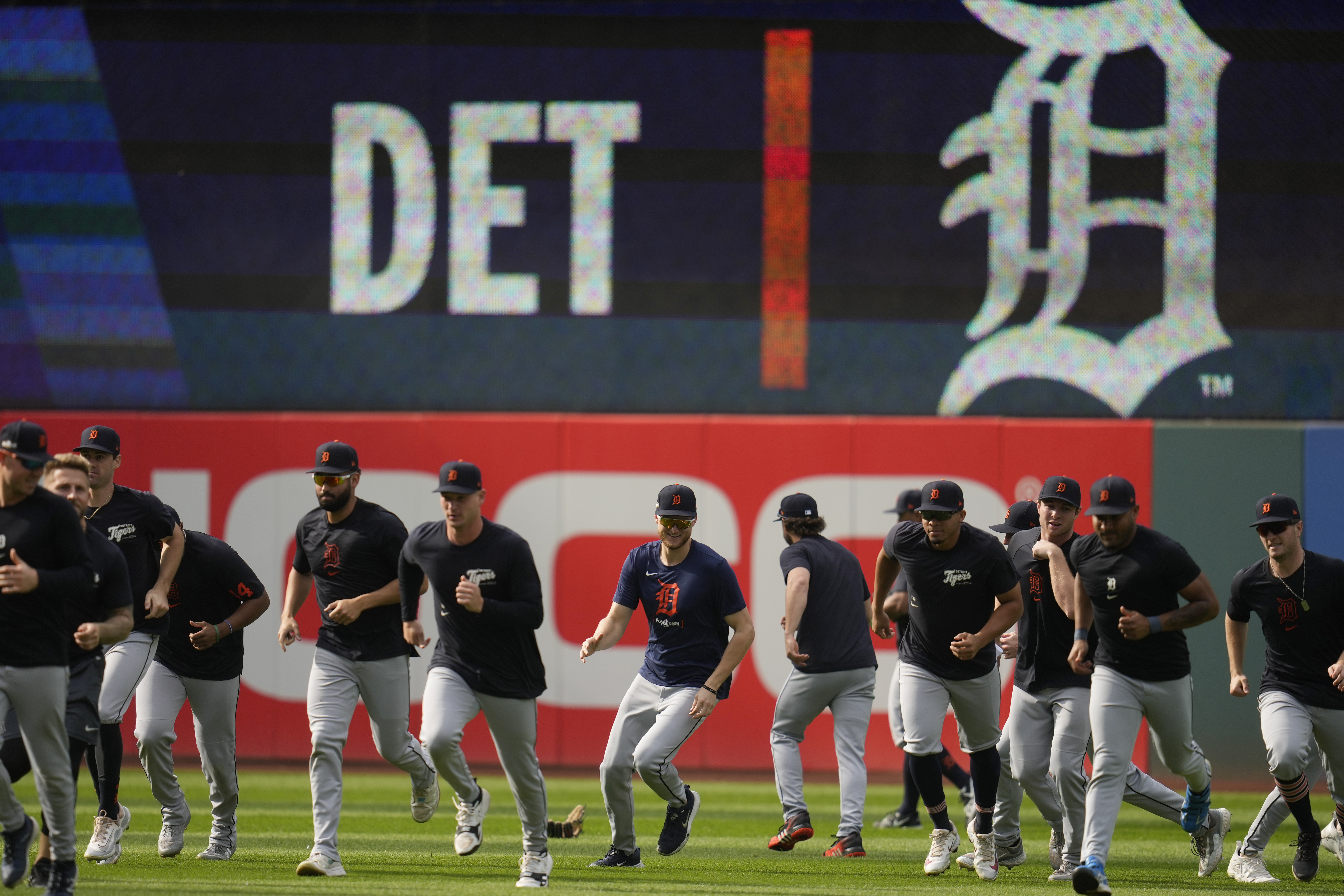 The Detroit Tigers run in from the outfield during a baseball workout in Cleveland, Friday, Oct. 4, 2024, in preparation for the American League Division Series against the Cleveland Guardians. (AP Photo/Sue Ogrocki)