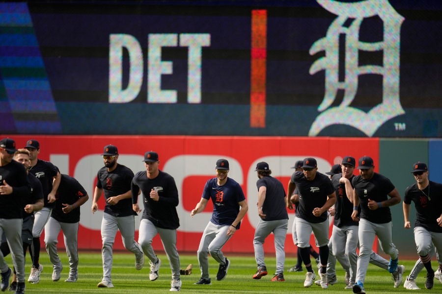 The Detroit Tigers run in from the outfield during a baseball workout in Cleveland, Friday, Oct. 4, 2024, in preparation for the American League Division Series against the Cleveland Guardians. (AP Photo/Sue Ogrocki)