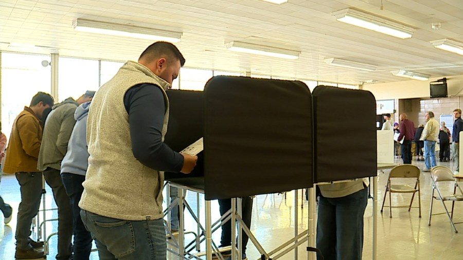 Grand Rapids voters fill out their ballots on Oct. 26, 2024, at Ottawa Hills High School, casting them on the first day of early in-person voting. (WOOD TV8)