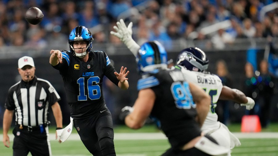 Detroit quarterback Jared Goff throws a pass to Brock Wright against the Seattle Seahawks. Goff finished the game a perfect 18 for 18 for 292 yards and two touchdowns. He also caught a touchdown pass in the 42-29 win. (Paul Sancya/AP)