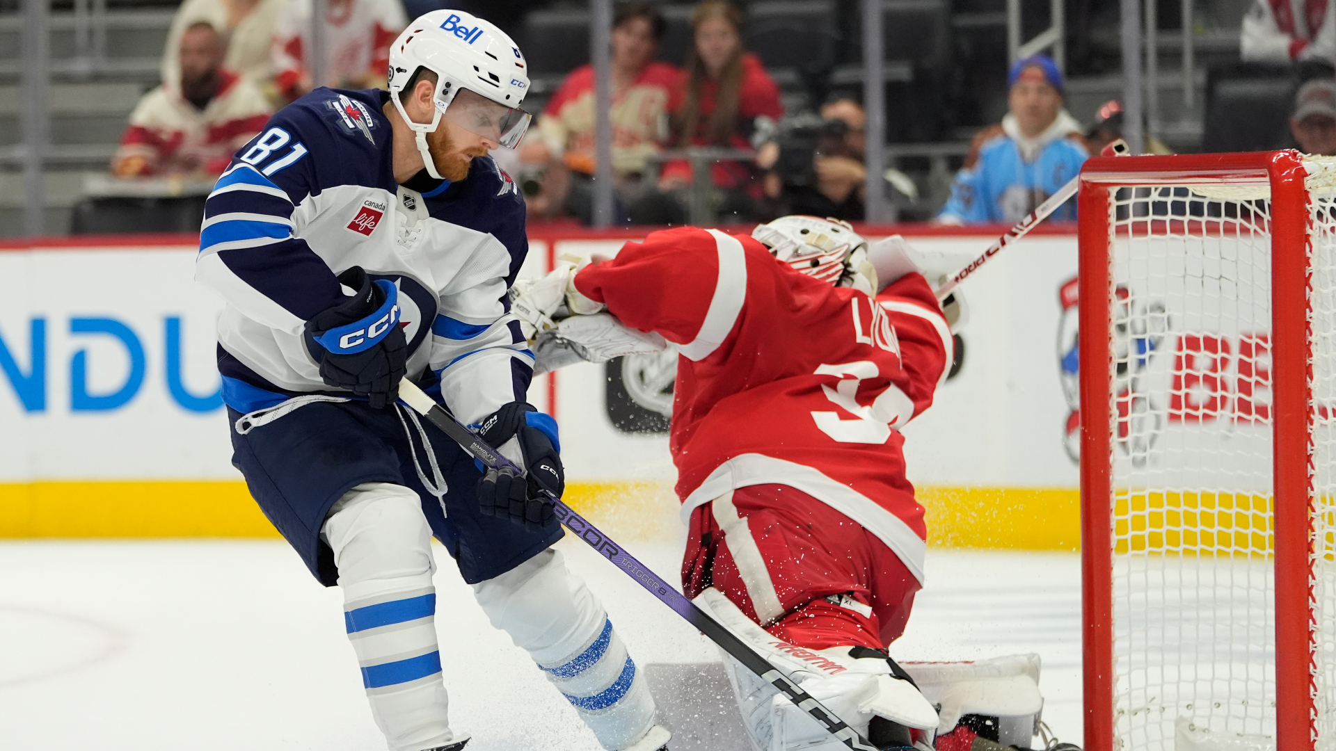 Winnipeg Jets left wing Kyle Connor (81) scores on Detroit Red Wings goaltender Alex Lyon (34) during the first period of an NHL hockey game, Wednesday, Oct. 30, 2024, in Detroit. (AP Photo/Carlos Osorio)
