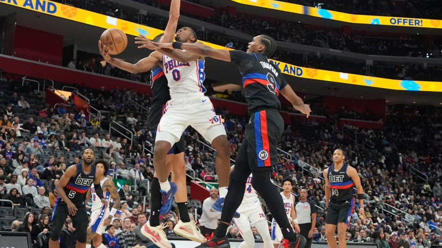 Philadelphia 76ers guard Tyrese Maxey (0) attempts a layup as Detroit Pistons forward Ausar Thompson (9) defends during the second half of an NBA basketball game, Saturday, Nov. 30, 2024, in Detroit. (AP Photo/Carlos Osorio)