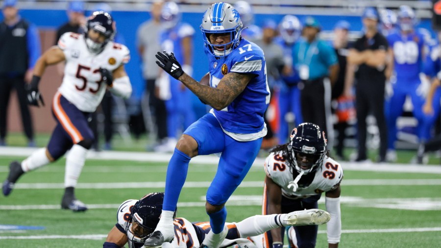 Detroit Lions wide receiver Tim Patrick (17) escapes the tackle of Chicago Bears safety Jonathan Owens (36) during the first half of an NFL football game, Sunday, Nov. 17, 2024, in Detroit. (AP Photo/Duane Burleson)