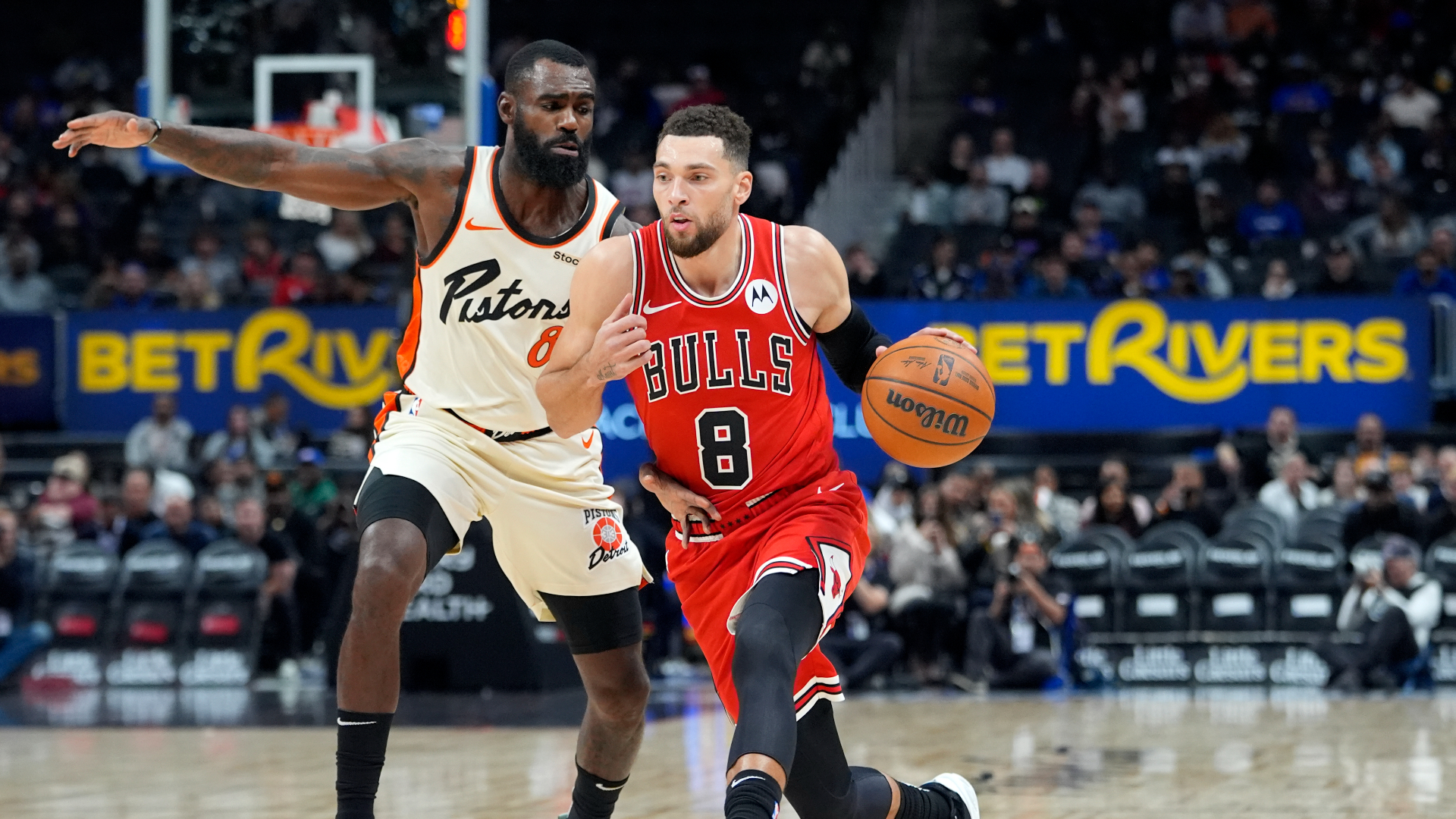 Chicago Bulls guard Zach LaVine (8) drives as Detroit Pistons forward Tim Hardaway Jr. (8) defends during the first half of an NBA basketball game, Monday, Nov. 18, 2024, in Detroit. (AP Photo/Carlos Osorio)