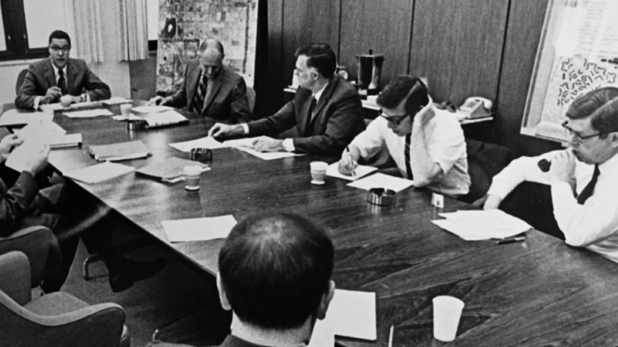 Michigan State University President Clifton Wharton Jr., top left, oversees a meeting of university officials. (Courtesy MSU)