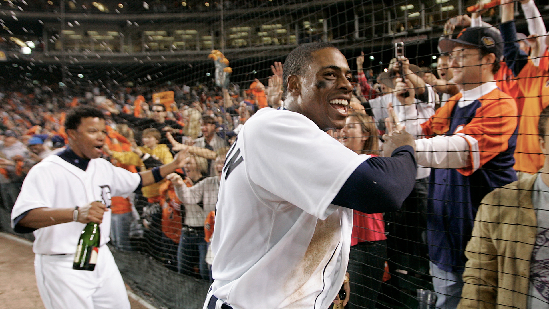 Curtis Granderson and Ramon Santiago celebrate with fans at Comerica Park after beating the New York Yankees to advance to the American League Championship Series on Oct. 7, 2006. (AP file)