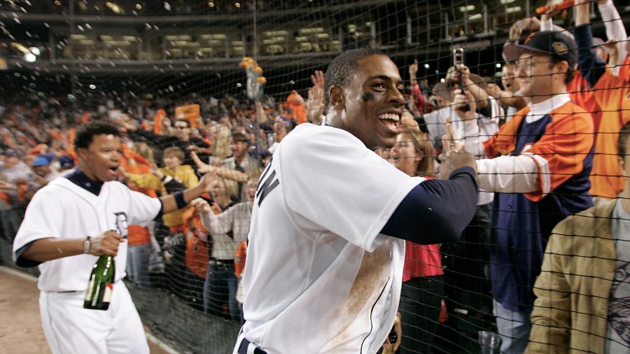 Curtis Granderson and Ramon Santiago celebrate with fans at Comerica Park after beating the New York Yankees to advance to the American League Championship Series on Oct. 7, 2006. (AP file)