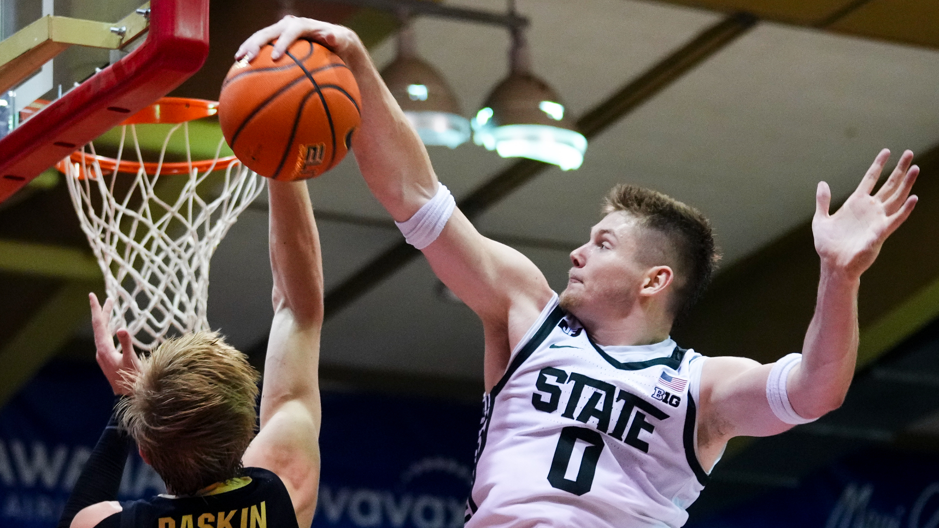 Michigan State forward Jaxon Kohler (0) blocks a shot from Colorado forward Trevor Baskin, left, during the second half of an NCAA college basketball game at the Maui Invitational Monday, Nov. 25, 2024, in Lahaina, Hawaii. Michigan State won 72-56. (AP Photo/Lindsey Wasson)