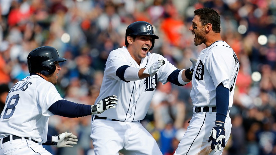 In his 2014 file photo, Ian Kinsler, right, celebrates a walk-off single with teammates Tyler Collins, left, and Nick Castellanos. (AP file)