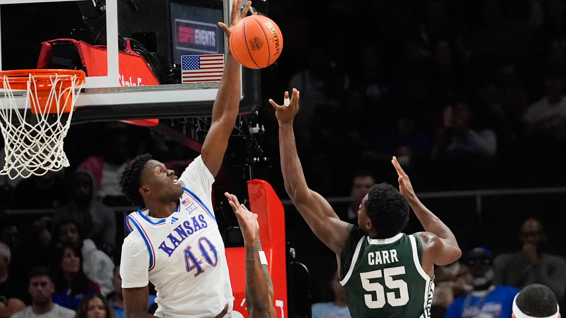 Michigan State forward Coen Carr (55) has his shot blocked by Kansas forward Flory Bidunga (40) during the first half of an NCAA college basketball game, Tuesday, Nov. 12, 2024, in Atlanta. (AP Photo/John Bazemore )