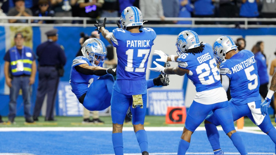 Detroit Lions wide receiver Amon-Ra St. Brown, left, celebrates with his teammates after scoring a touchdown during their 52-6 win over Jacksonville on Sunday, Nov. 17, 2024, at Ford Field. (Rick Osentoski/AP)