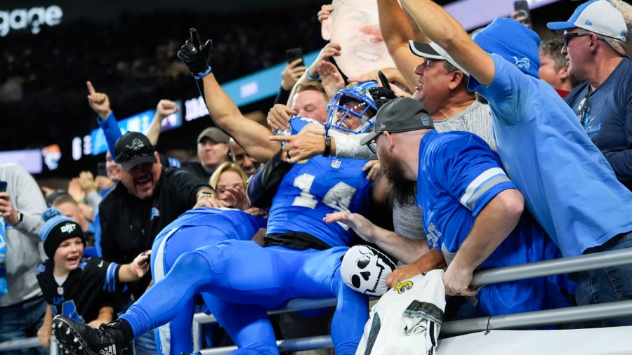 Detroit Lions wide receiver Amon-Ra St. Brown celebrates a touchdown in the stands during Detroit's 52-6 win over Jacksonville on Sunday, Nov. 17, 2024, at Ford Field. (Carlos Osorio/AP)
