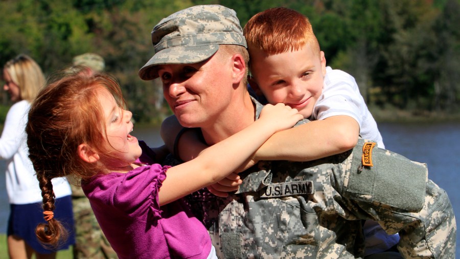 Maj. Lisa Jaster holds her daughter Victoria, 3, and her son Zachary, 7, following Ranger School graduation ceremonies on October 16, 2015, at Victory Pond in Columbus, Ga. Jaster, who is the third woman to earn the Ranger Tab, entered Ranger training with Capt. Kristen Griest and 1st Lt. Shaye Haver, who were the first two women to graduate from Ranger School during ceremonies on August 21. (Robin Trimarchi/Columbus Ledger-Enquirer/TNS)