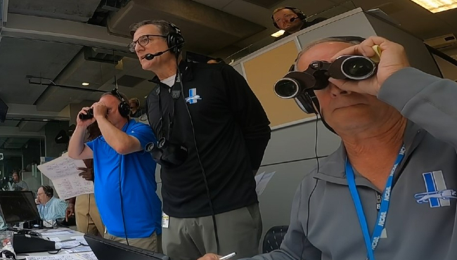 Mike Bratta, far right, the statistician for the Detroit Lions Radio Network, has become a minor celebrity among Lions fans for his role in game broadcasts, highlighted by the team's popular "Calls of the Game" videos. (Courtesy Detroit Lions/YouTube)