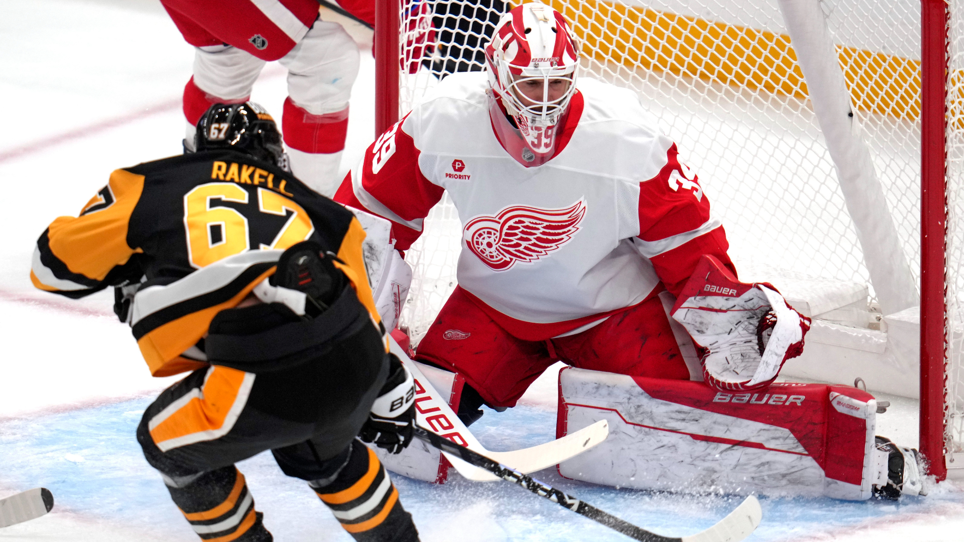 Detroit Red Wings goaltender Cam Talbot (39) blocks a shot by Pittsburgh Penguins' Rickard Rakell (67) during the first period of an NHL hockey game Wednesday, Nov. 13, 2024, in Pittsburgh. (AP Photo/Gene J. Puskar)