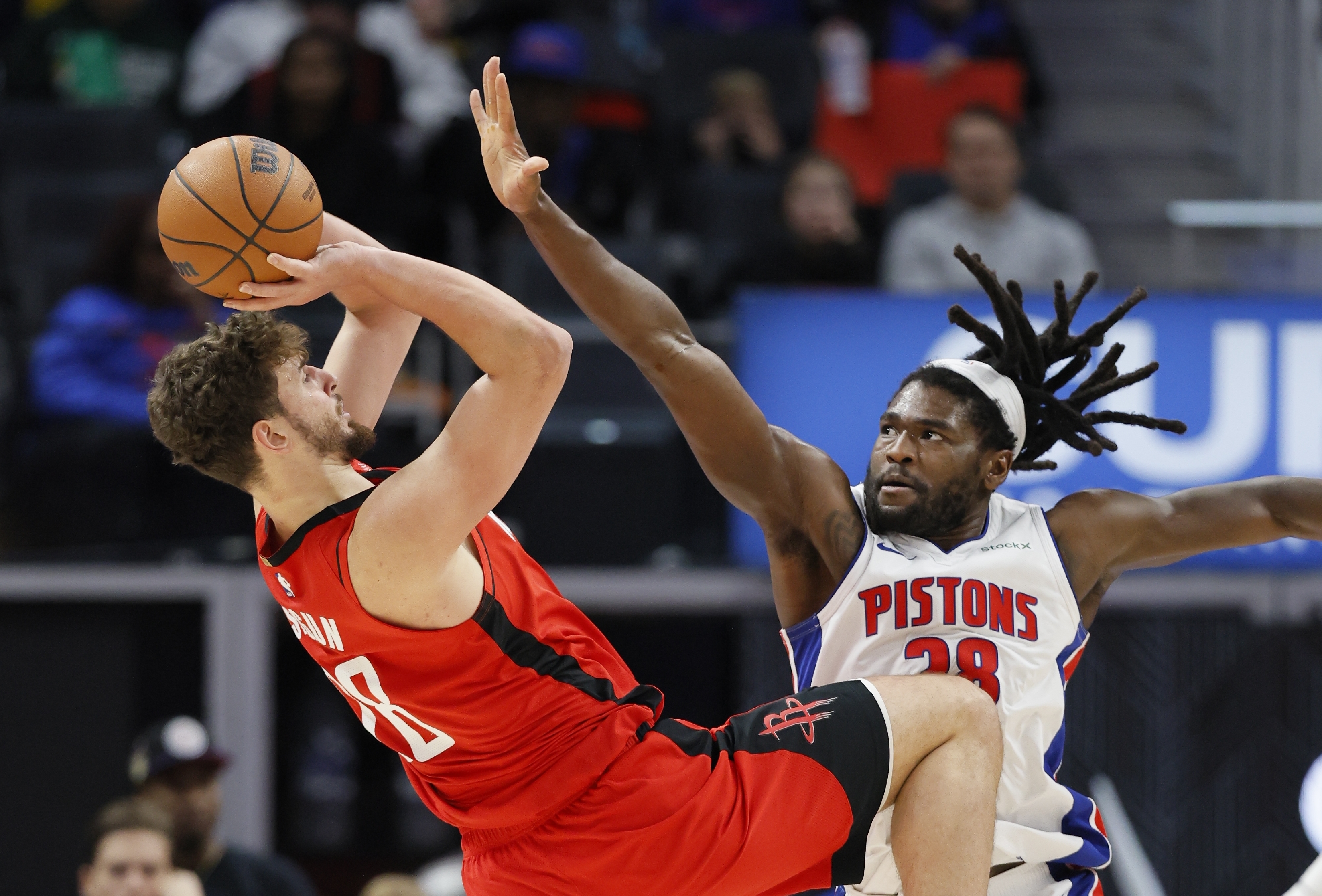 Houston Rockets center Alperen Sengun, left, looks to shoot against Detroit Pistons center Isaiah Stewart, right, during the first half of an NBA basketball game Sunday, Nov. 10, 2024, in Detroit. (AP Photo/Duane Burleson)