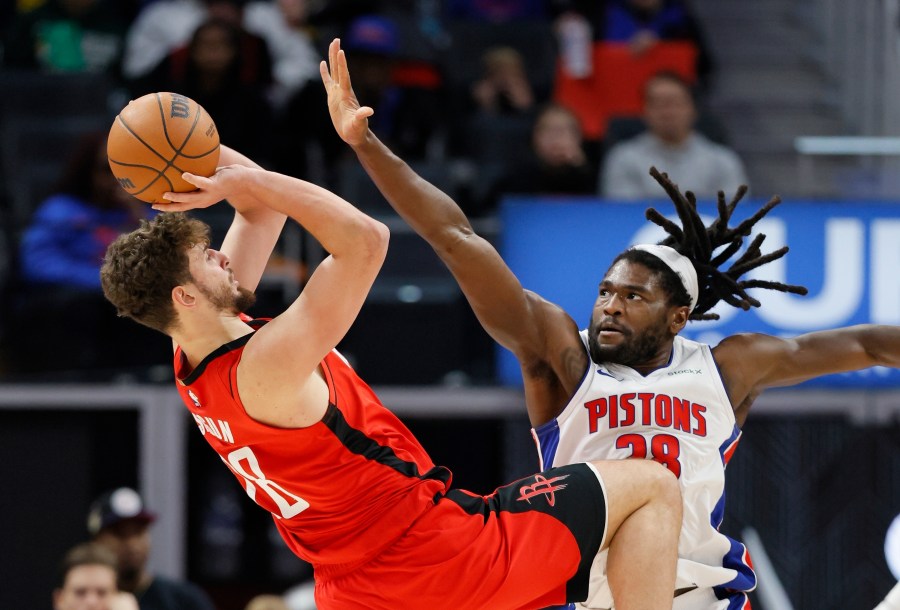 Houston Rockets center Alperen Sengun, left, looks to shoot against Detroit Pistons center Isaiah Stewart, right, during the first half of an NBA basketball game Sunday, Nov. 10, 2024, in Detroit. (AP Photo/Duane Burleson)