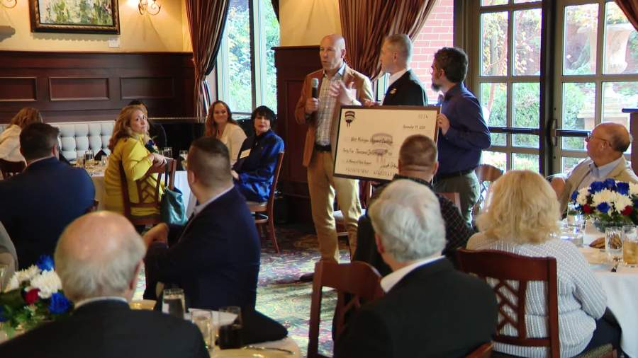 Armed Forces Thanksgiving presents a $45,000 check to the West Michigan Veterans Coalition during a Nov. 11, 2024, event at Grand Valley State University in Grand Rapids.