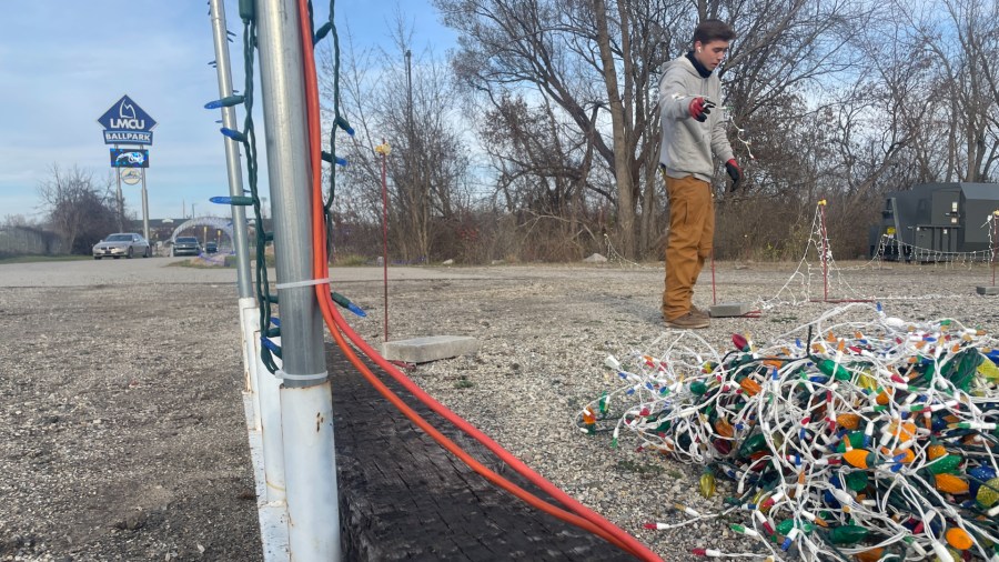 Workers repair damage after the Christmas Lite Show at LMCU Ballpark north of Grand Rapids was vandalized. (Nov. 27, 2024)