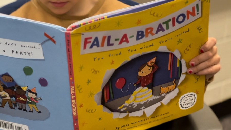 A child reads "Fail-A-Bration" in Andy Losik's classroom. (Nov. 18, 2024)