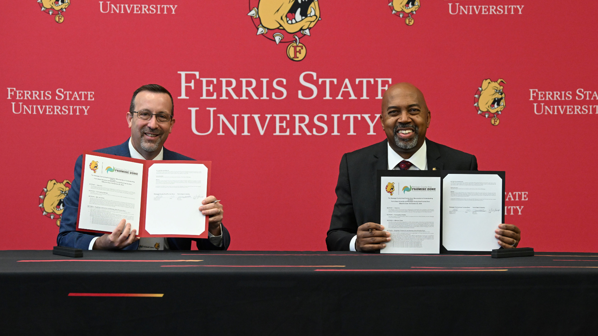 Newaygo County Area Promize Zone Chairperson Blake Prewitt and Ferris State President Bill Pink sign an agreement on Nov. 22, 2024. (Courtesy Ferris State)