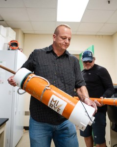 Eric Olson with a tube full of rye pulled from a Lake Huron shipwreck. (Courtesy Michigan State University/Jonah Brown)