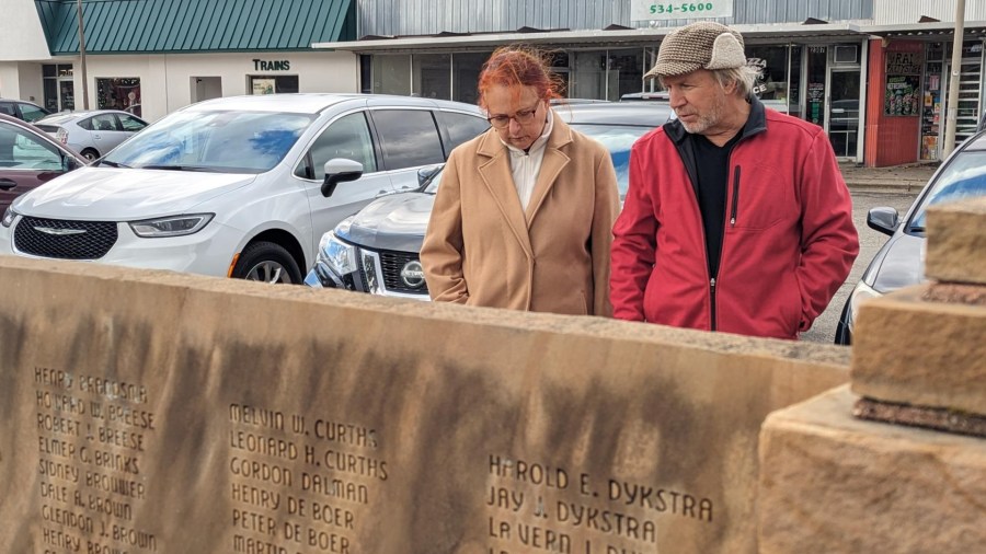Estelle Slootmaker (left) looks at the name of her father Boyce Slootmaker on the veterans memorial wall in Wyoming. (Nov. 11, 2024)