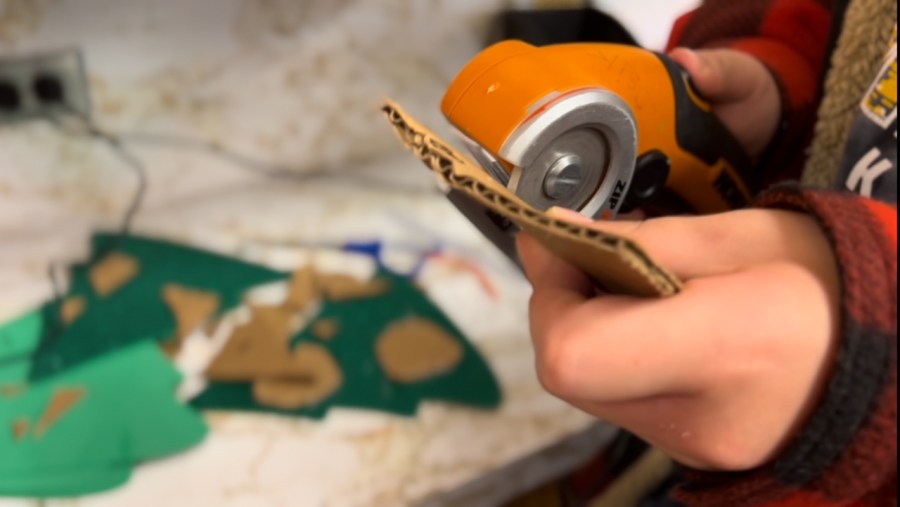 A child uses the ZipSnip cardboard cutter in Andy Losik's classroom. (Nov. 18, 2024)