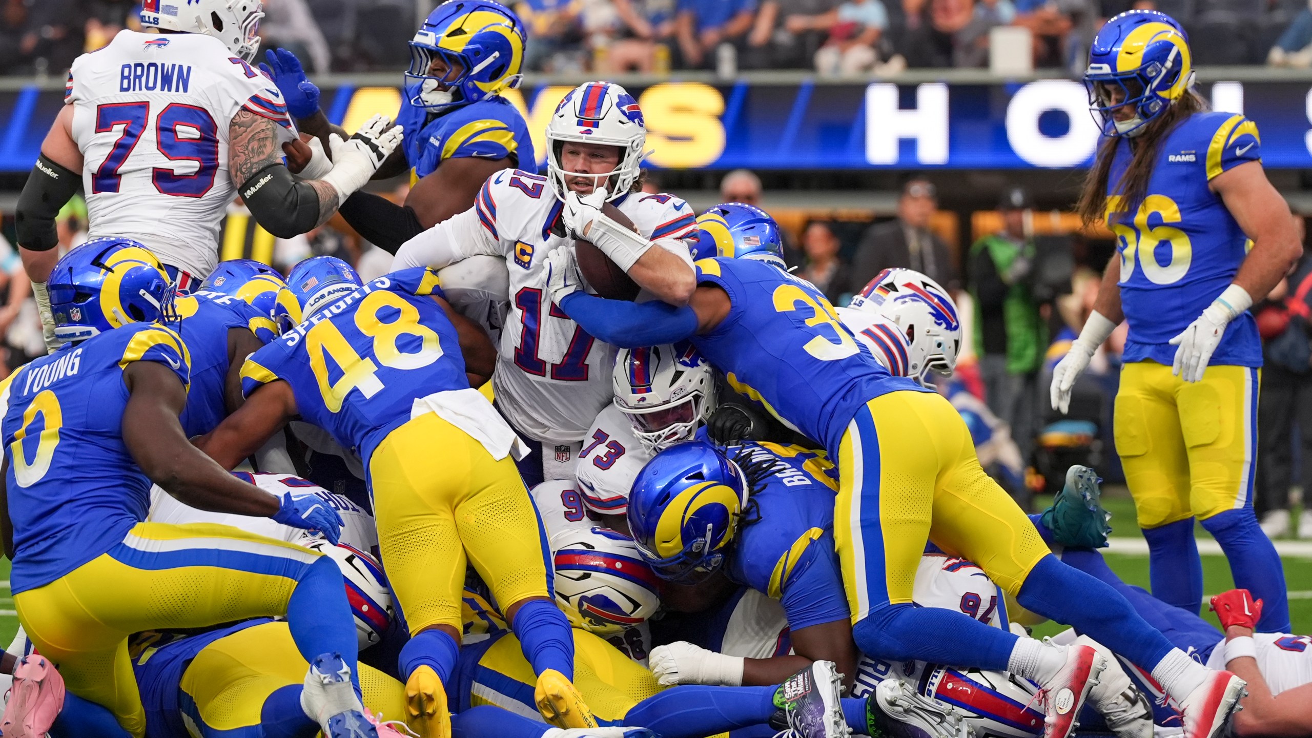 Buffalo Bills quarterback Josh Allen, center, scores a touchdown on a keeper against the Los Angeles Rams during the first half of an NFL football game, Sunday, Dec. 8, 2024, in Inglewood, Calif. (AP Photo/Gregory Bull)