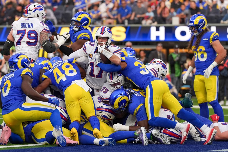 Buffalo Bills quarterback Josh Allen, center, scores a touchdown on a keeper against the Los Angeles Rams during the first half of an NFL football game, Sunday, Dec. 8, 2024, in Inglewood, Calif. (AP Photo/Gregory Bull)