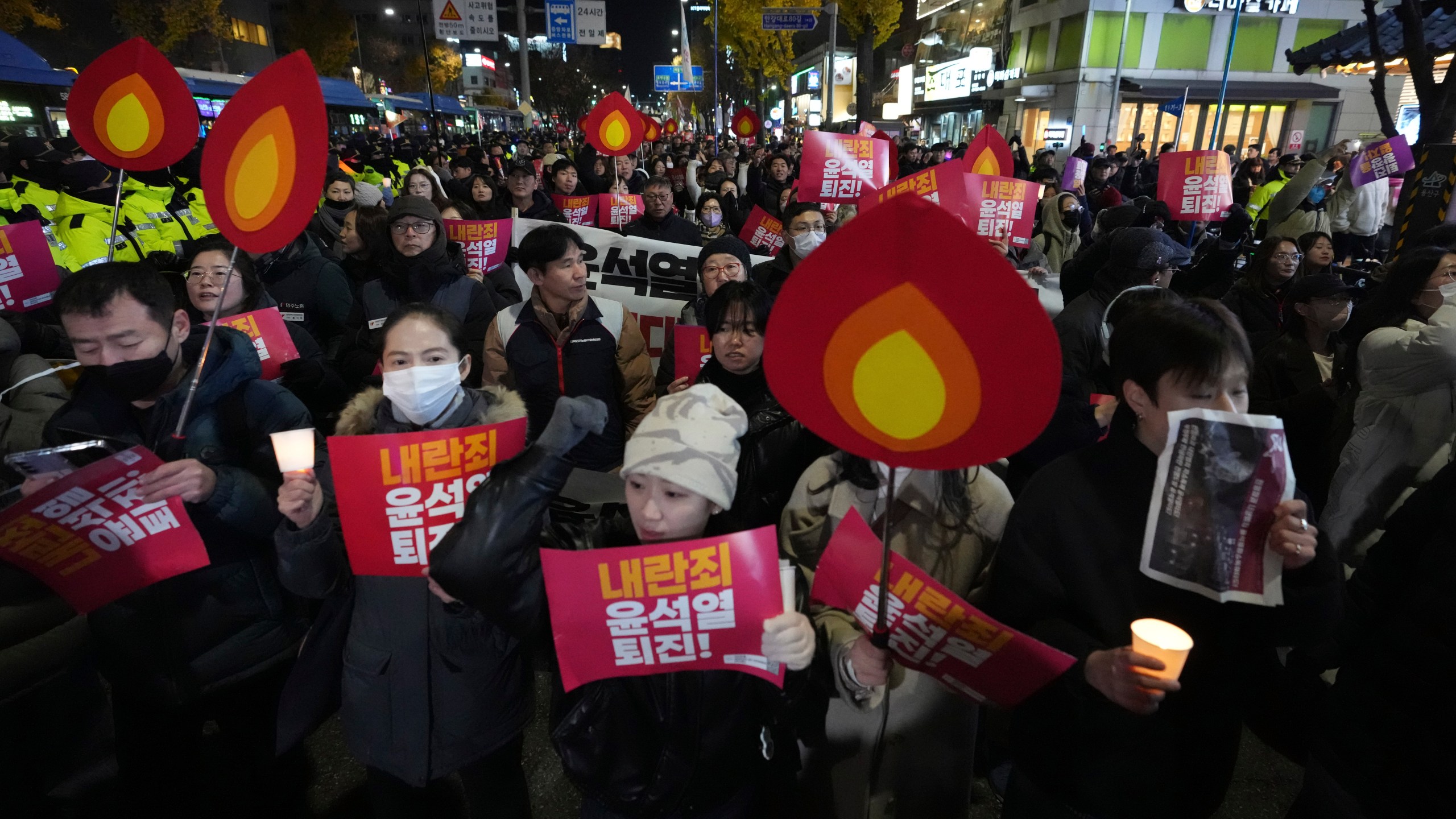 FILE - Protesters march to the presidential office after a candlelight vigil against South Korean President Yoon Suk Yeol in Seoul, South Korea, Wednesday, Dec. 4, 2024. (AP Photo/Lee Jin-man, File)