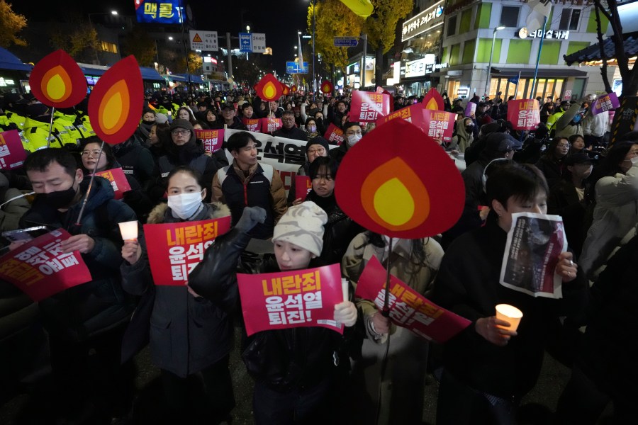 FILE - Protesters march to the presidential office after a candlelight vigil against South Korean President Yoon Suk Yeol in Seoul, South Korea, Wednesday, Dec. 4, 2024. (AP Photo/Lee Jin-man, File)