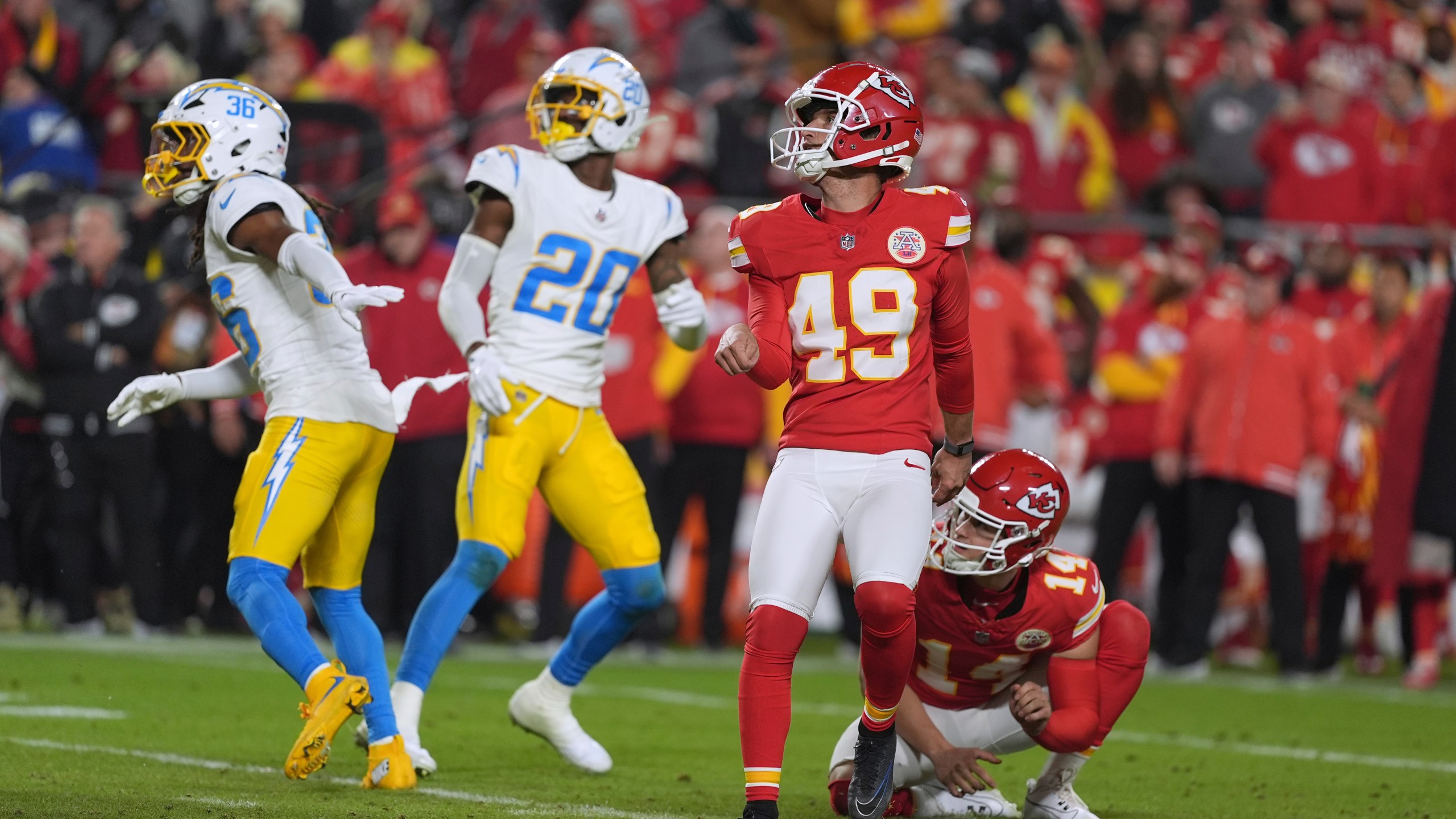 Kansas City Chiefs kicker Matthew Wright (49) watches his game-winning field goal as time expires in an NFL football game against the Los Angeles Chargers Sunday, Dec. 8, 2024, in Kansas City, Mo. (AP Photo/Charlie Riedel)