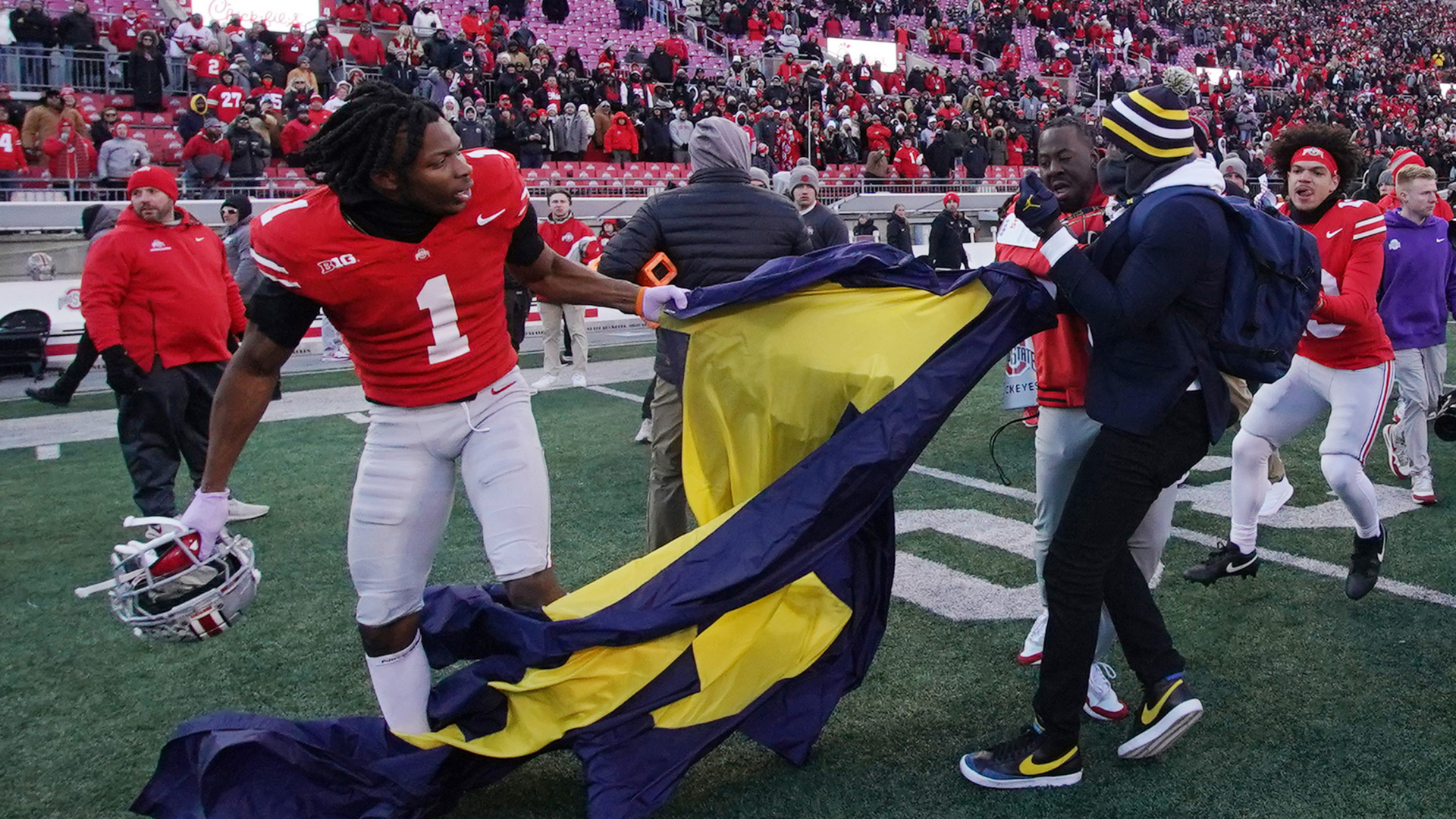 COLUMBUS, OHIO - NOVEMBER 30: Davison Igbinosun #1 of the Ohio State Buckeyes grabs a Michigan flag following his team's defeat against the Michigan Wolverines at Ohio Stadium on November 30, 2024 in Columbus, Ohio. (Photo by Jason Mowry/Getty Images)