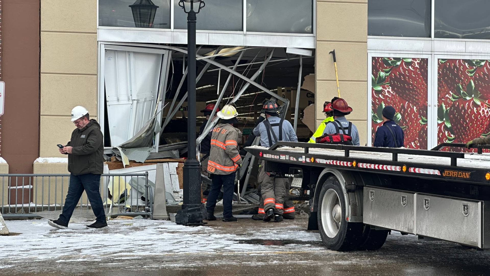 Crews work to remove a car from the Cascade Township Meijer following a crash on Dec. 5, 2024.