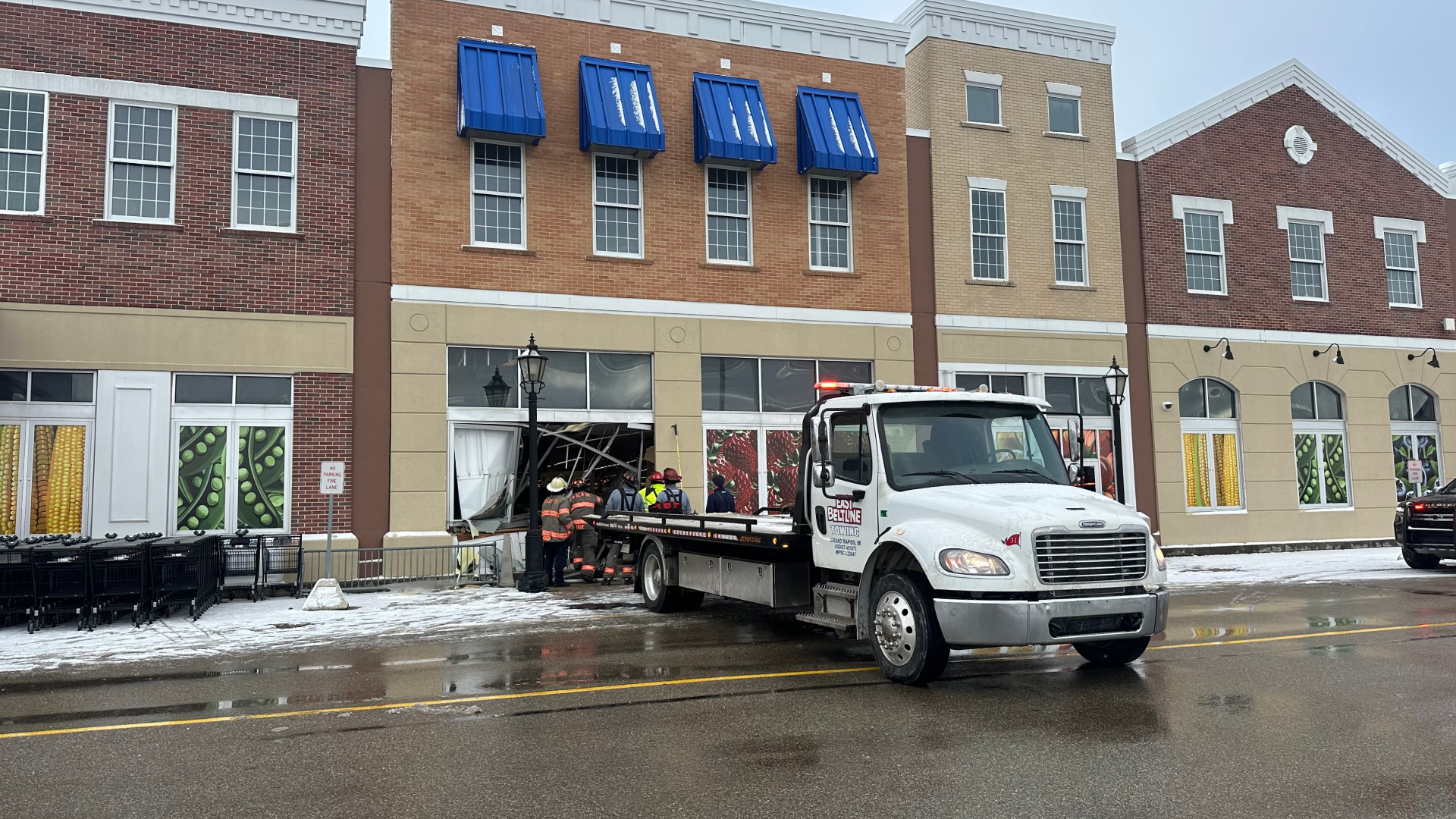 Crews work to remove a car from the Cascade Township Meijer following a crash on Dec. 5, 2024.