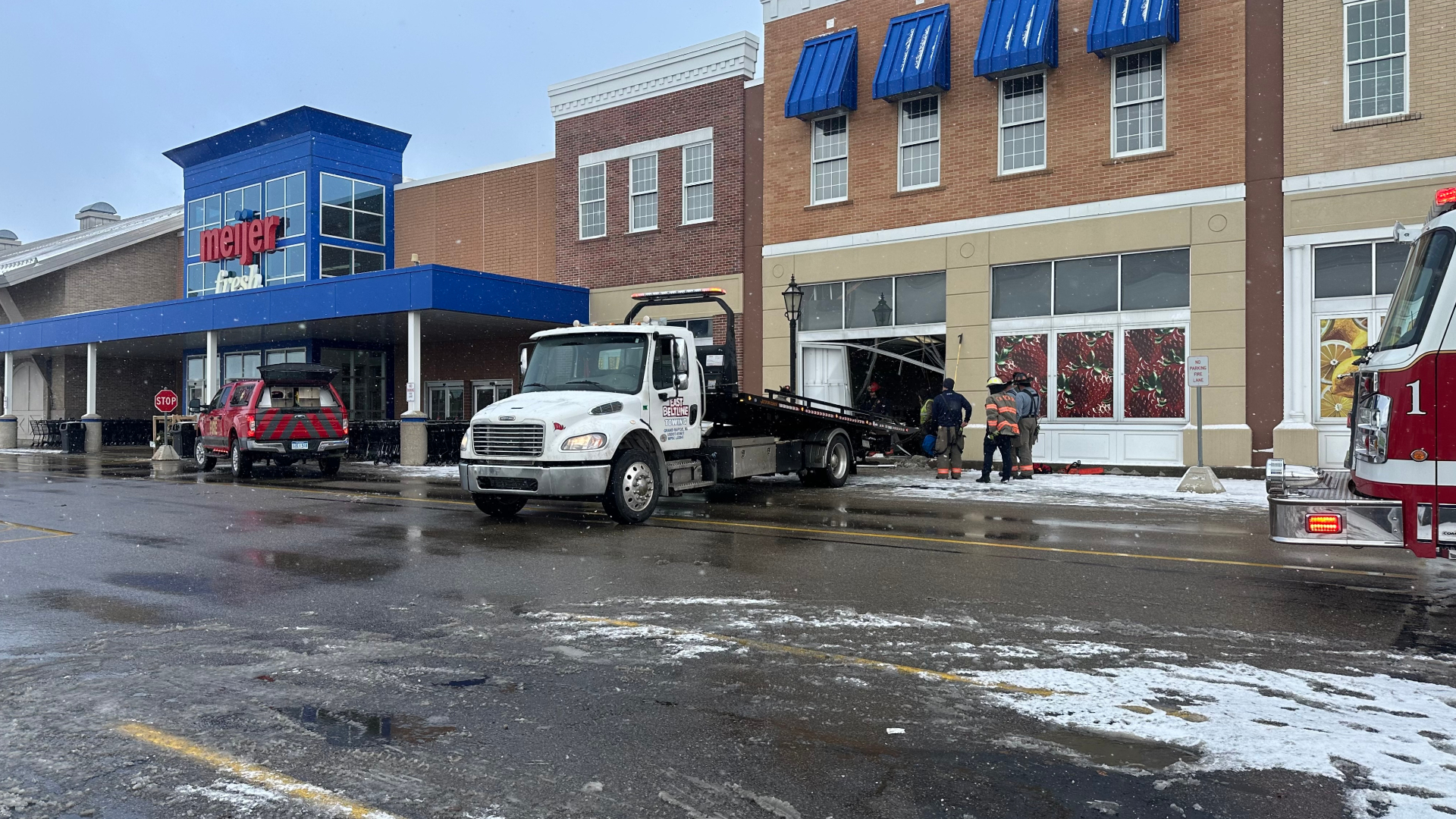 Crews work to remove a car from the Cascade Township Meijer following a crash on Dec. 5, 2024.