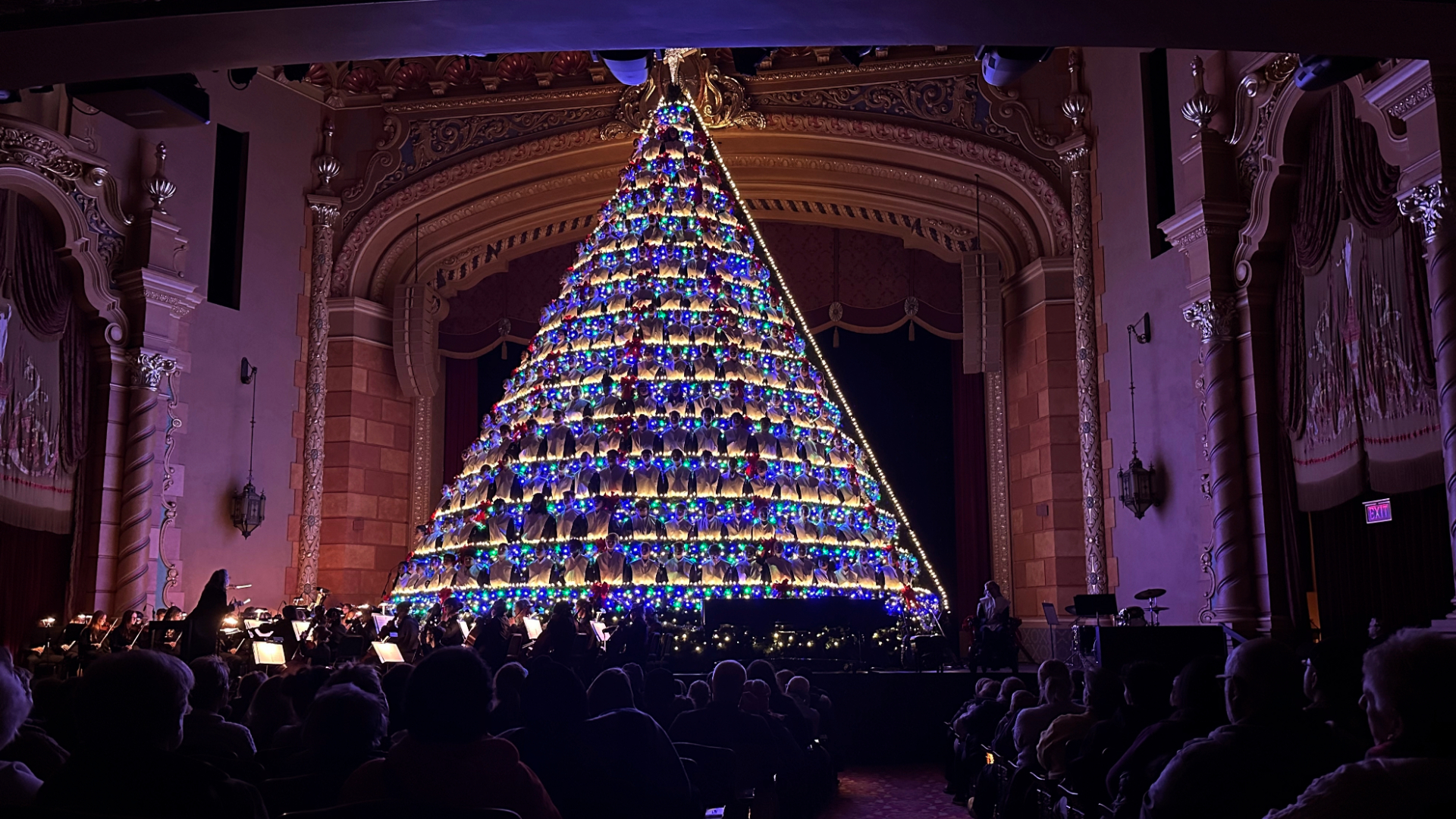 High school students sing while standing in a 67-foot-tall structure as part of the annual Mona Shores Singing Christmas Tree show Tuesday, Dec. 3, 2024, in Muskegon, Mich. (AP Photo/Mike Householder)